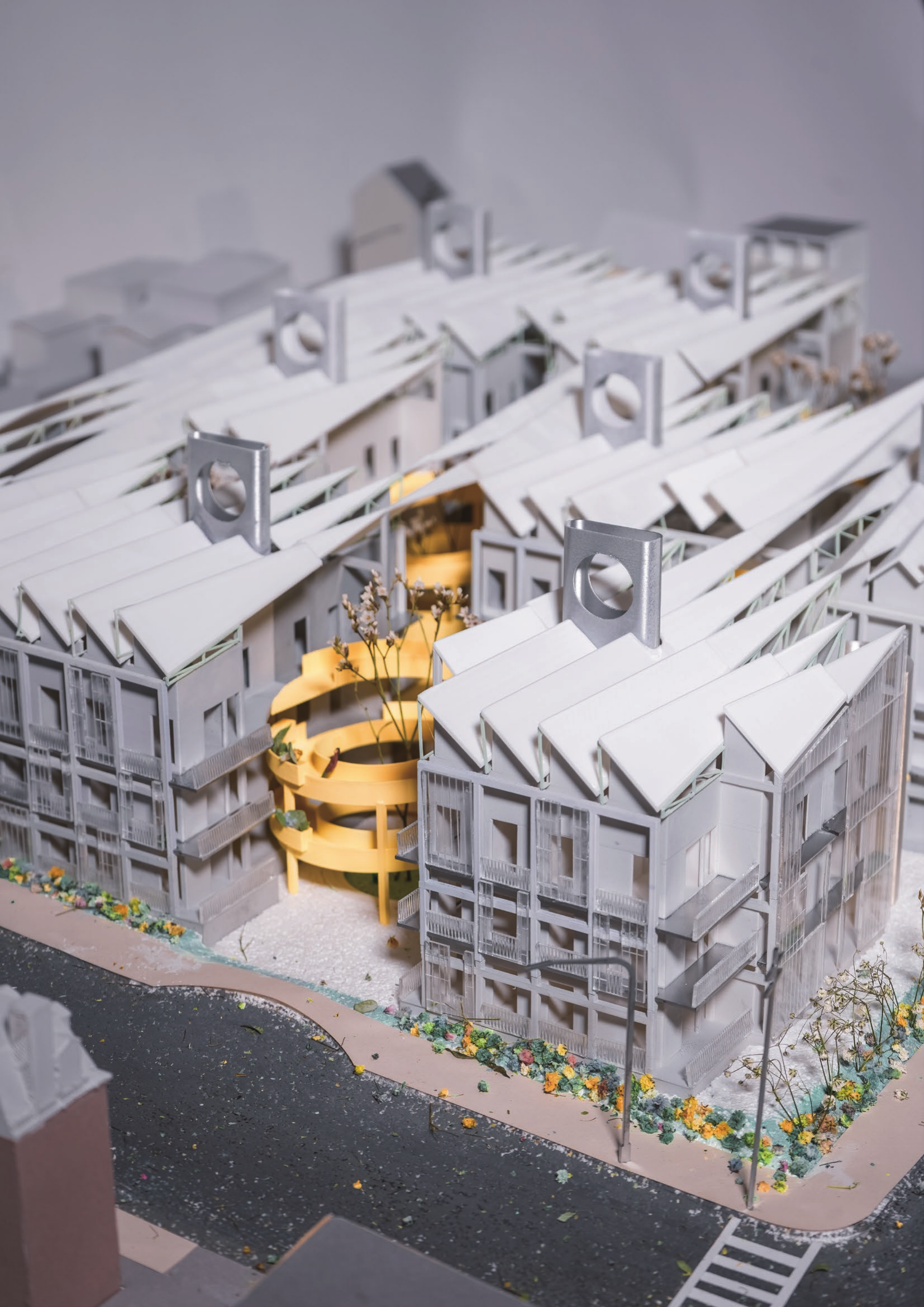 Sectional perspective of housing gathered around a glowing solar chimney
