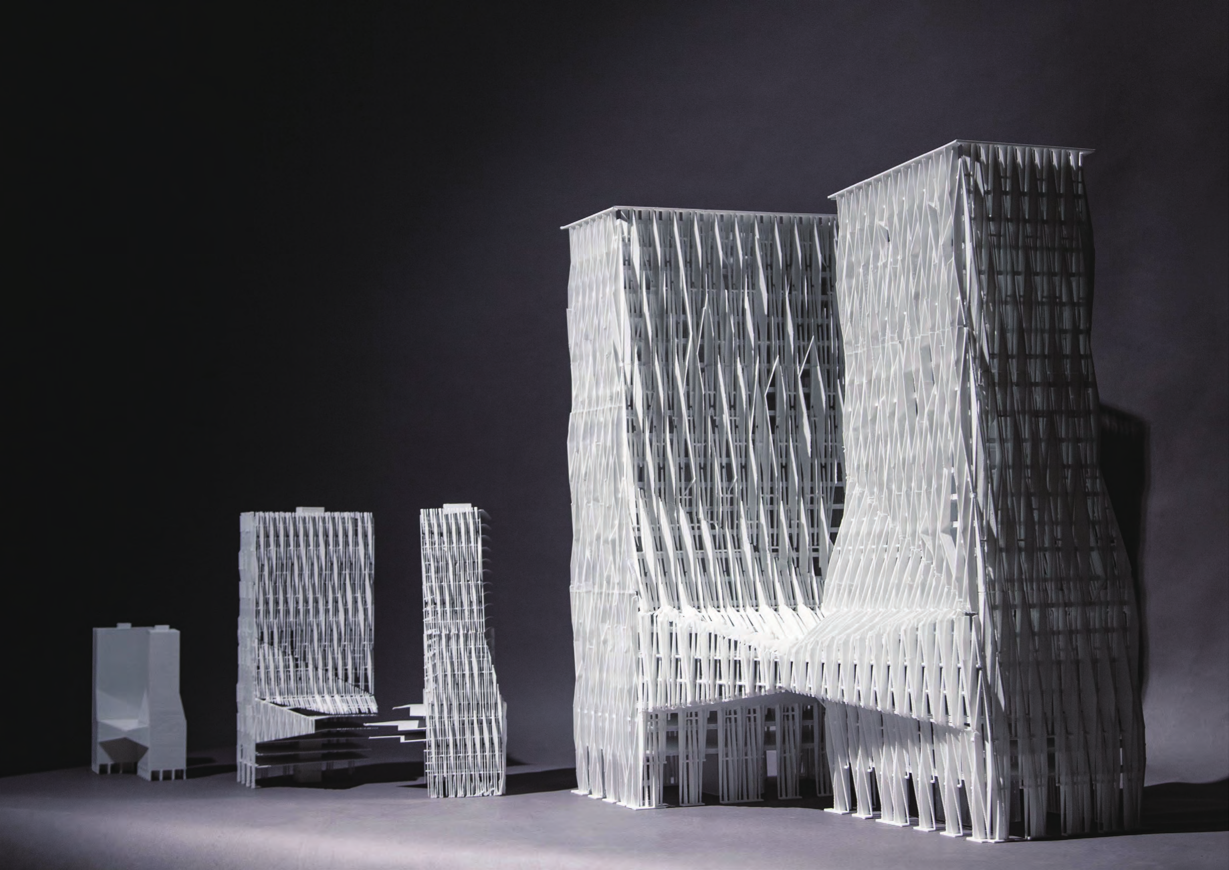 Final twin-tower model with a wave-shaped facade alongside its design studies